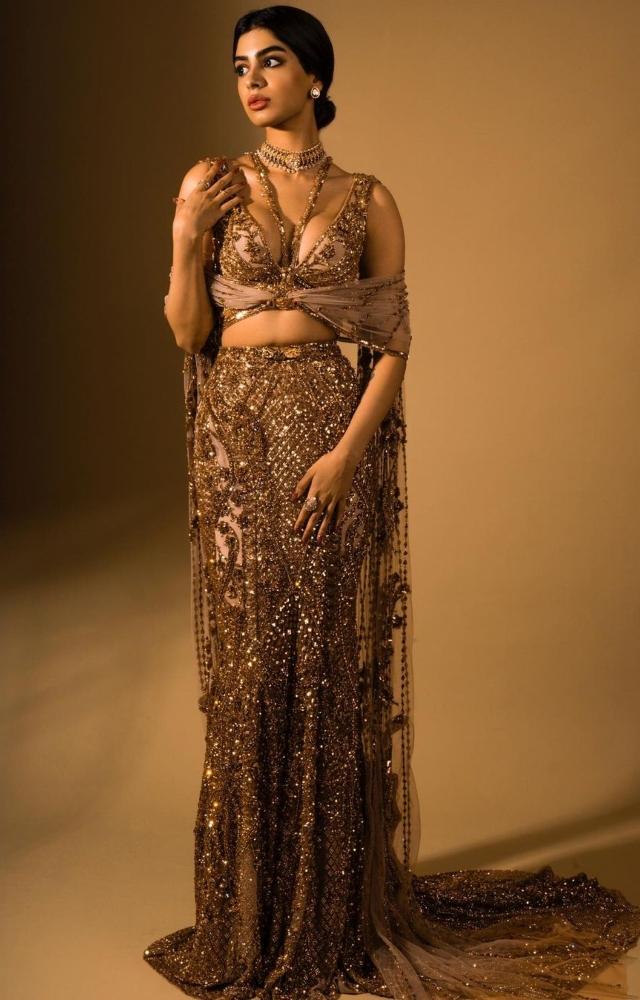 For the NMACC Gala, Khushi Kapoor wore a golden lehenga and blouse with a cape. She completed her look for with a choker